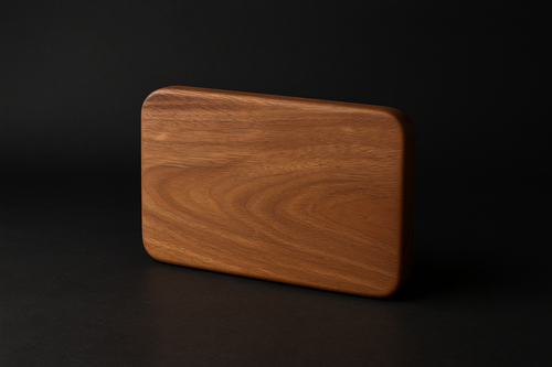 Wooden cutting board on a black background